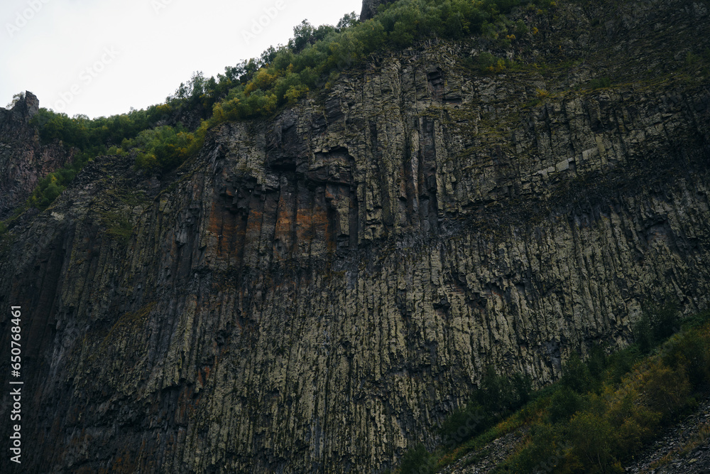 The gorge of the Truso Valley. Beautiful steep basalt rocks. Amazing nature of mountainous Georgia, Kazbegi region. Beautiful landscape of the national park. The gorge of the Truso Valley. Beautiful steep basalt rocks. Amazing nature of mountainous Georgia, Kazbegi region. Beautiful landscape of the national park.