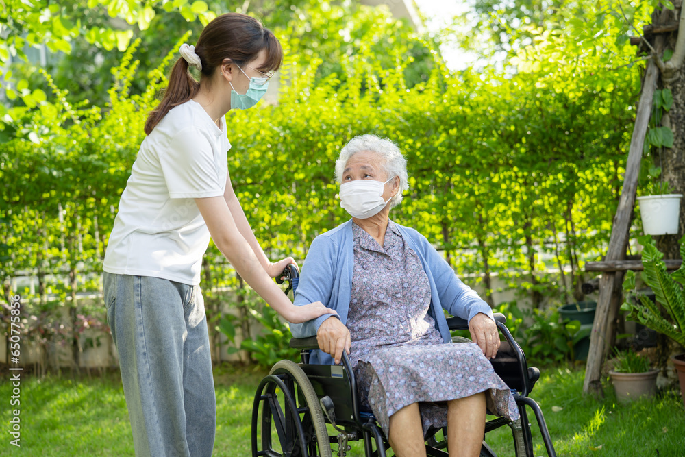 caregiver help and care Asian senior woman patient wearing mask sitting on wheelchair at nursing hospital ward, healthy strong medical concept. caregiver help and care Asian senior woman patient wearing mask sitting on wheelchair at nursing hospital ward, healthy strong medical concept.