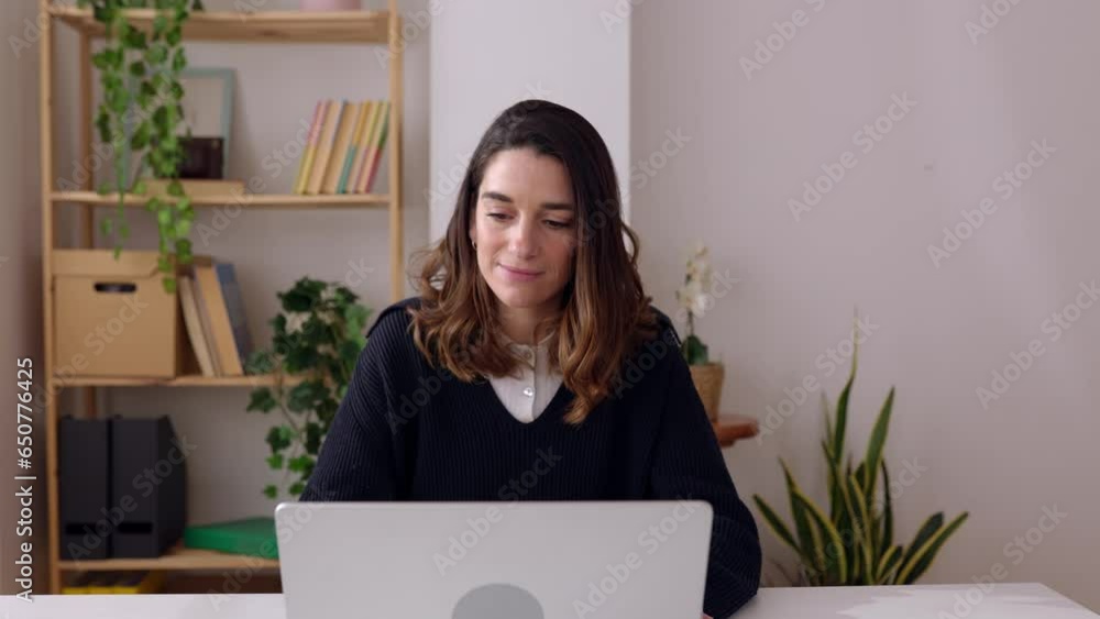 Euphoric young adult woman celebrating success or victory triumph sitting at home desk with laptop computer. Online win, job opportunity, exam result or good news concept. Euphoric young adult woman celebrating success or victory triumph sitting at home desk with laptop computer. Online win, job opportunity, exam result or good news concept.
