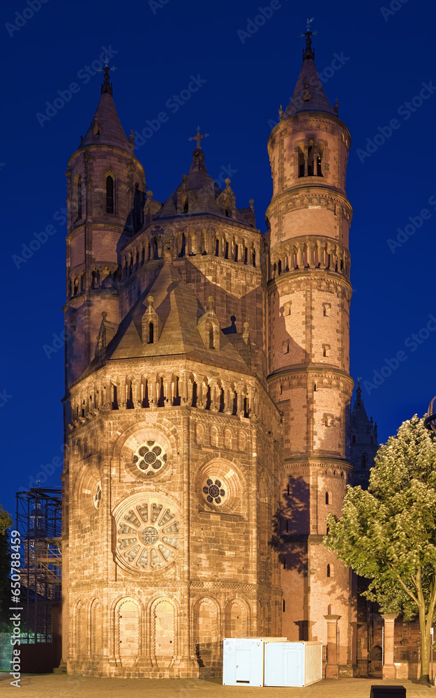 West facade of Worms Cathedral in dusk, Germany. The cathedral was built from about 1130 to 1181. This is one of the three Rhenish imperial cathedrals besides the Mainz Cathedral and Speyer Cathedral.