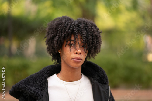 portrait of a serious beautiful afro black young woman with curly hair