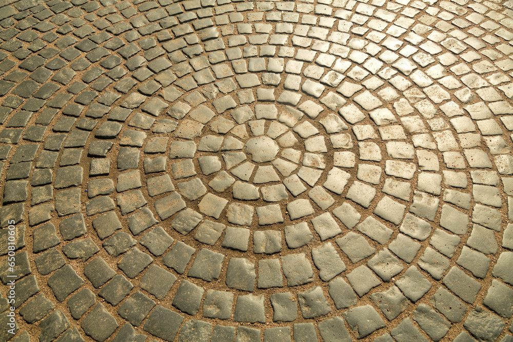 The pavement is paved with stones in the shape of a circle