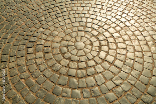 The pavement is paved with stones in the shape of a circle