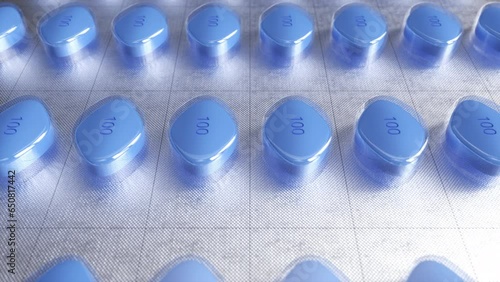 
Blue pills in blister pack move along conveyor in modern pharmaceutical factory. Tablet and capsule manufacturing process. Close-up of medical drug production line. Mass production concept. Loop photo