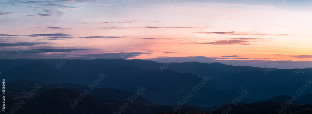 Panorama landscape of the Bulgarian nature with a dramatic sunrise over the mountains.