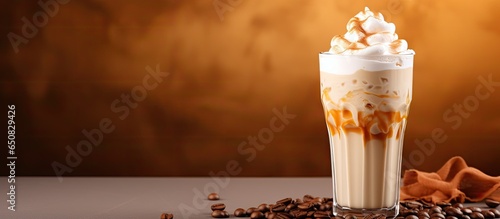 Milk based cold coffee cocktail with whipped cream on a cream background space for text photo