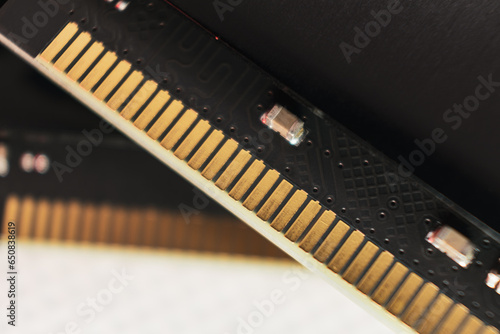 DDR4 DRAM memory module golden electrical contact macro. Computer RAM chipset close-up. Desktop PC memory hardware components