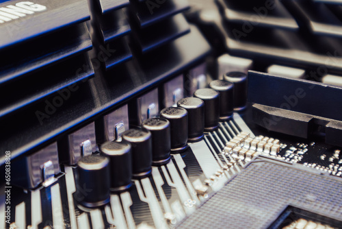 Motherboard with sockets and microchips close-up on a desktop PC. Computer hardware chipset components. Tech electronics background photo