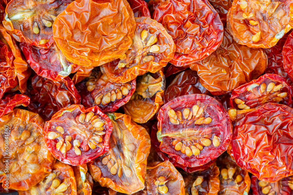 A pile of red and orange dried cherry tomatoes