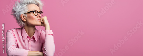 strict serious woman, teacher or businesswoman, with glasses in a pink shirt, banner with copy space