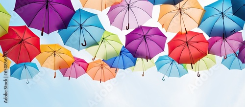 Obraz w ramie Various vibrant flying umbrellas