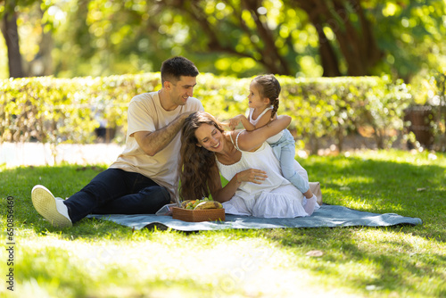 Young family having a picnic and having fun in the park