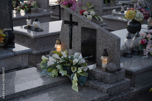 Catholic grave decorated with white flowers and candles. photo
