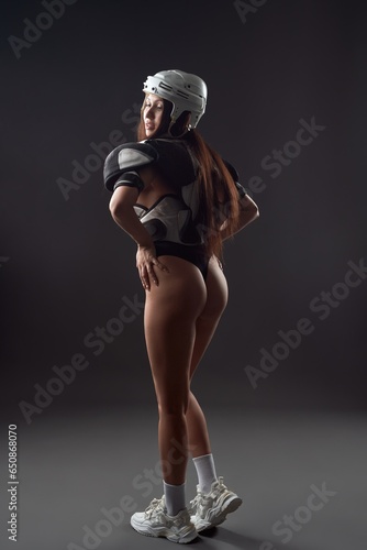 Sexy female sports player with padded buttocks in uniform photo