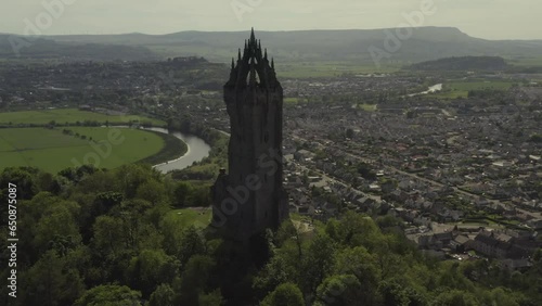 Aerial view of Wallace Monument national landmark on Abeey Craig hill and Stirling cityscape at sunny day in Scotland, UK photo