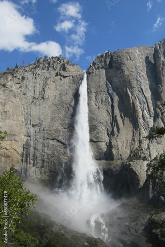 Vertical shot of a beautiful waterfall flowing through the mountains in Yosemite National Park, USA