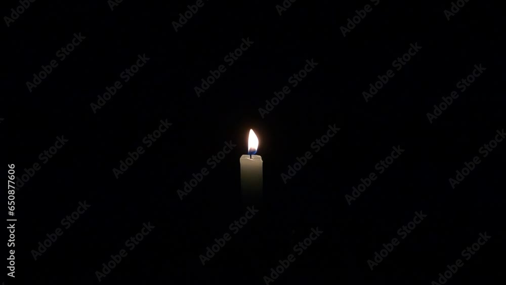 Lit candle that won't be blown isolated on the empty black background Lit candle that won't be blown isolated on the empty black background