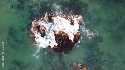 Rocks surrounded by waves at the Algarve coast in Portugal.
