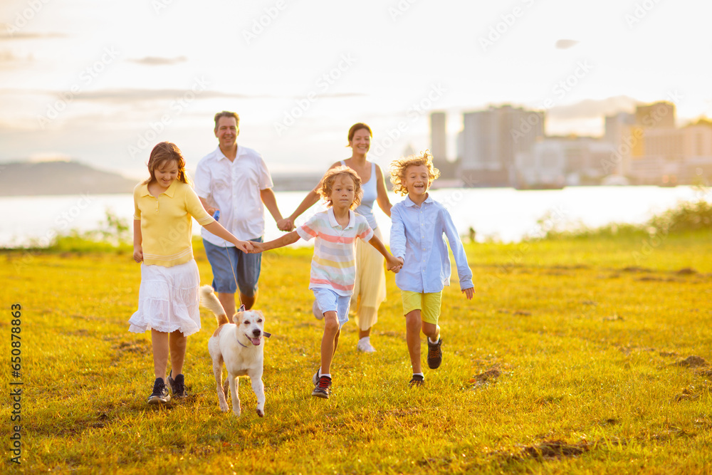 Family with kids running outdoor at sunset. Family with kids running outdoor at sunset.