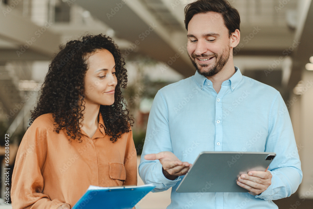 Portrait of attractive smiling businesspeople, hispanic bearded man holding digital tablet Portrait of attractive smiling businesspeople, hispanic bearded man holding digital tablet
