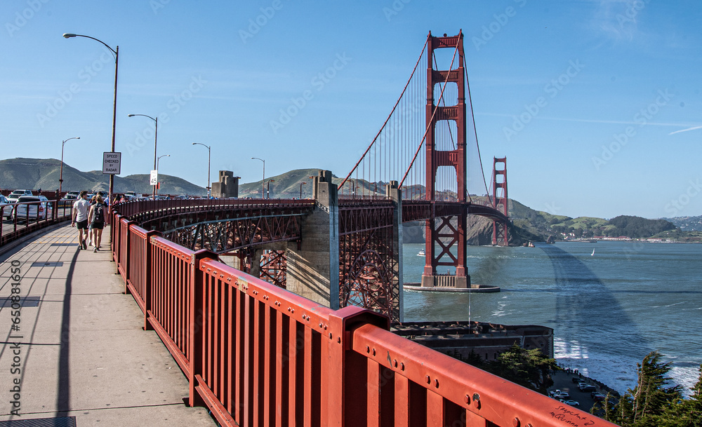 Beautiful view of the Golden Gate Bridge with people walking on it Beautiful view of the Golden Gate Bridge with people walking on it