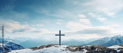 Skyward Christian cross above mountains