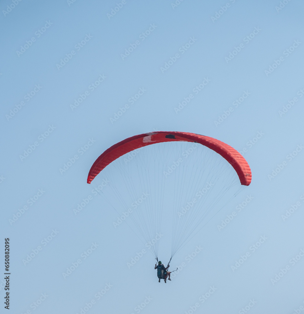 paragliding in the air from far blue sky paragliding in the air from far blue sky