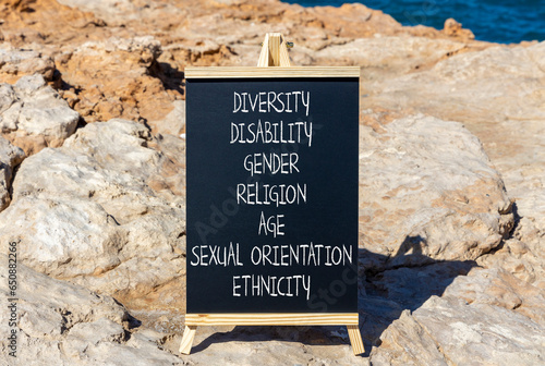 Diversity ethnicity gender age sexual orientation religion disability words written on black chalk blackboard on a beautiful stone background. Equality diversity ethnicity gender disability concept.
