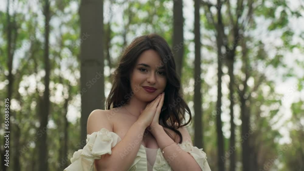 Portrait of an attractive Caucasian girl in Off Shoulder white dress posing in the forest Portrait of an attractive Caucasian girl in Off Shoulder white dress posing in the forest