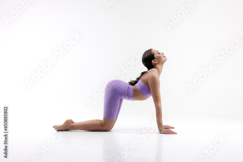 Young attractive girl practicing yoga isolated on white background. Concept of healthy life and natural balance between body and mental development. Full length