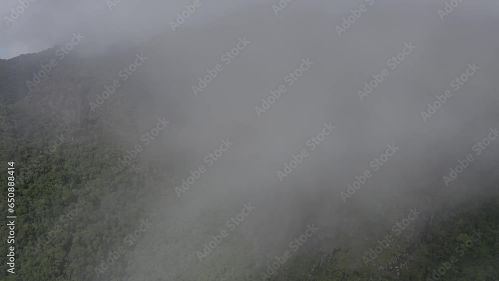 Flying through clouds above Tres Picos State Park natural landscape, mountain peaks and forest scenery aerial view in Rio de Janeiro, Brazil Flying through clouds above Tres Picos State Park natural landscape, mountain peaks and forest scenery aerial view in Rio de Janeiro, Brazil