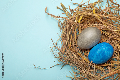 фотографія Top view of colorful painted eggs on a nest for Easter