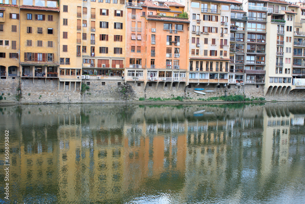 Row of colorful buildings reflected in a river