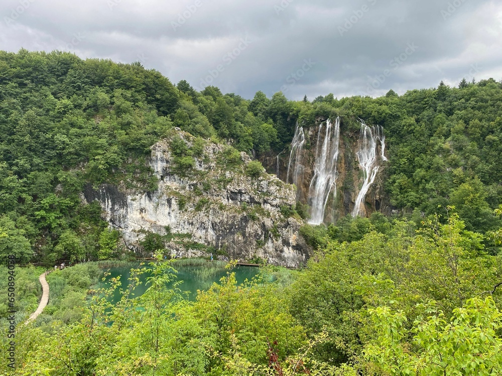 Waterfall at Croatia national park surrounded by green lush trees