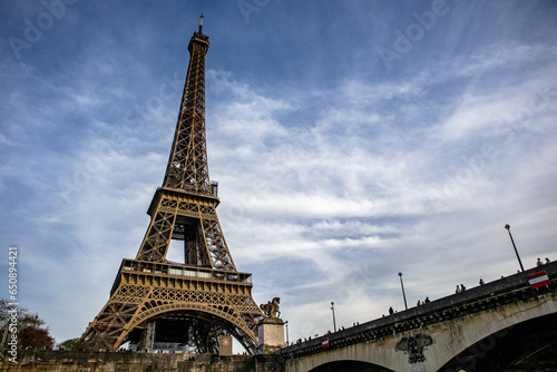 Low angle shot of the historical Eiffel Tower and a bridge over the Seine River in Paris  France
