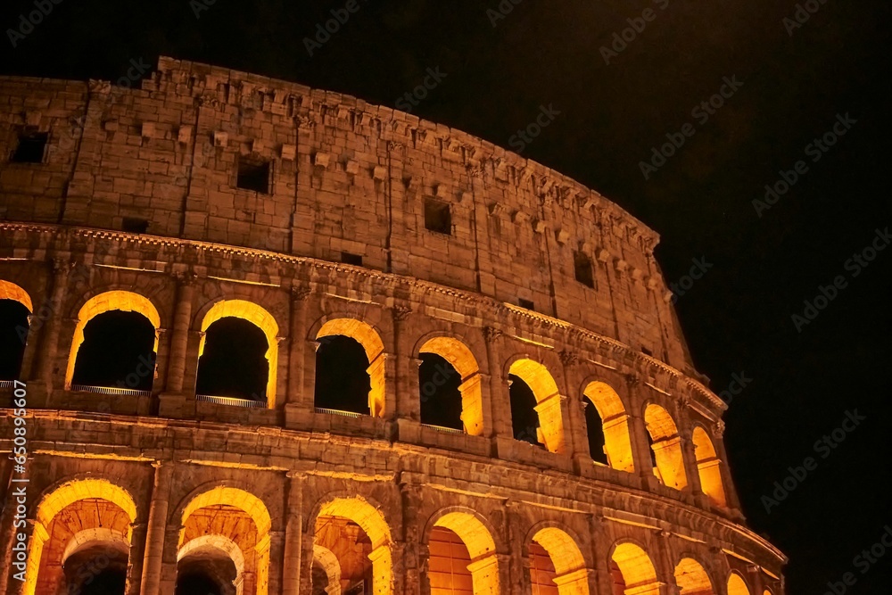 Colosseum in Rome illuminated with bright lights during the night