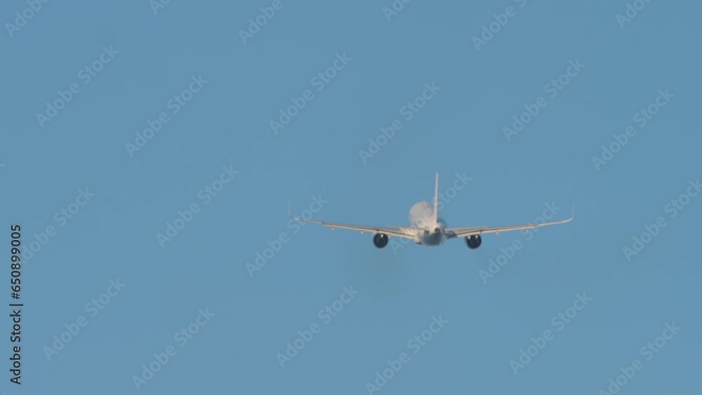 Airplane climb after takeoff in blue sky. Passenger flight departs. Airliner leaving Airplane climb after takeoff in blue sky. Passenger flight departs. Airliner leaving