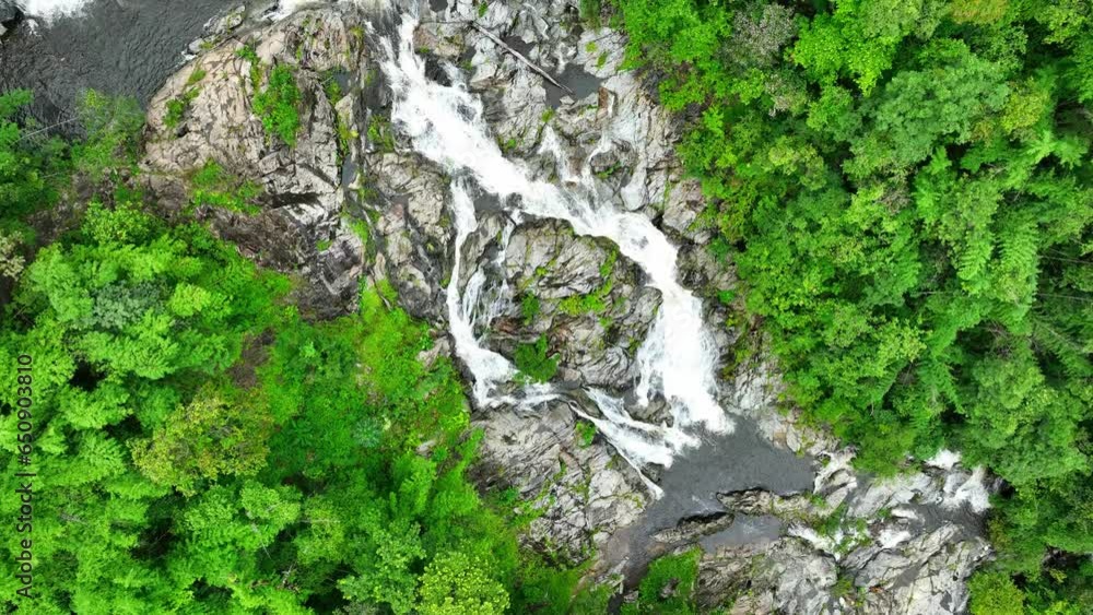 A stunning waterfall, nature's masterpiece, cascades gracefully amidst lush greenery, its crystal-clear waters glistening in the sunlight. Khlong Nam Lai Waterfall, Khlong Lan National Park, Thailand. A stunning waterfall, nature's masterpiece, cascades gracefully amidst lush greenery, its crystal-clear waters glistening in the sunlight. Khlong Nam Lai Waterfall, Khlong Lan National Park, Thailand.