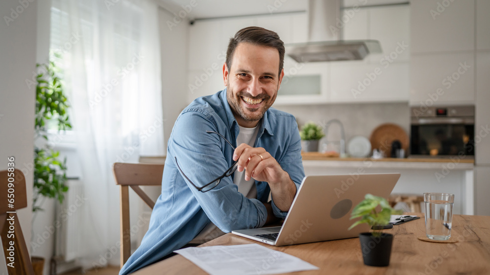 Fototapeta premium one man adult caucasian work on laptop at home happy smile