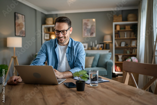 one man adult caucasian work on laptop at home happy smile