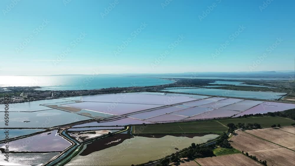 Soaring view of the blushing salt terrains of Aigues-Mortes.
