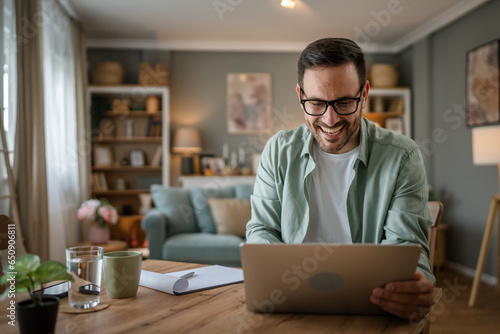 one man adult caucasian work on laptop at home happy smile photo