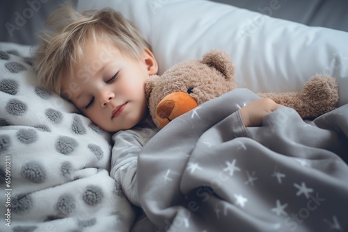 adorable little boy sleeping hugging his stuffed toy