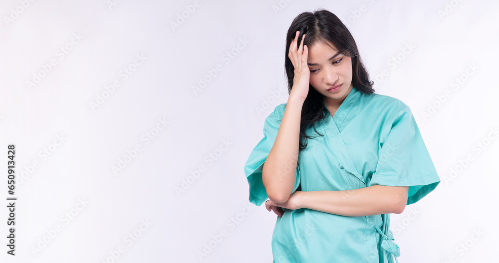 Unhappy woman patient gown headache or pensive anxiety problem troubled sadness standing over isolated white background. Unhealthy teenager holding hand stress headache disease. Insurance health care. Unhappy woman patient gown headache or pensive anxiety problem troubled sadness standing over isolated white background. Unhealthy teenager holding hand stress headache disease. Insurance health care.