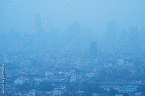 Fototapeta Naklejka Na Ścianę i Meble -  Skyscraper mist bad problem unhealthy toxic pm2.5 weather smog bangkok city in morning. Fog skyline air pollution over building downtown mist quality poor office architecture cityscape view at bangkok