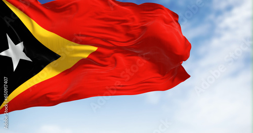 National flag of East Timor waving in the wind on a clear da photo