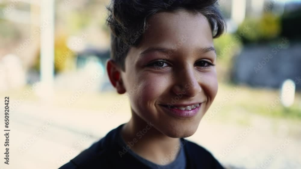 Handsome young boy looking at camera smiling, close-up caucasian pre-teen child feeling happy Handsome young boy looking at camera smiling, close-up caucasian pre-teen child feeling happy