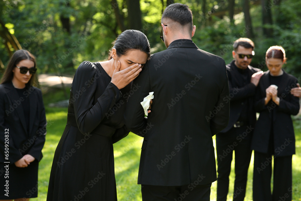 Sad people in black clothes mourning outdoors. Funeral ceremony Sad people in black clothes mourning outdoors. Funeral ceremony