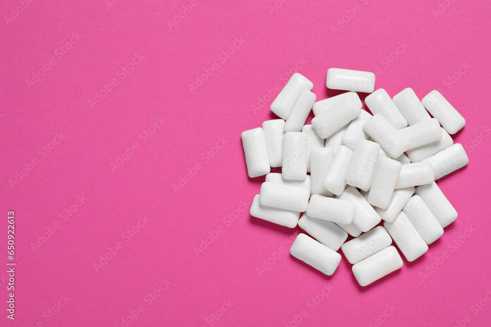 Tasty white chewing gums on pink background, top view Tasty white chewing gums on pink background, top view