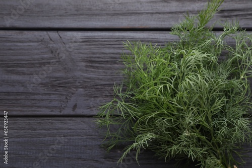 Fresh dill on wooden table, top view. Space for text